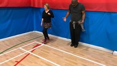 A white woman and a black man dancing in a gymnasium