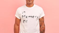 A man wearing a white tee shirt that says 'in memory of'