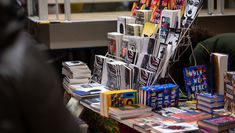 Literature is displayed on a stand atop a trestle table in Central's atrium