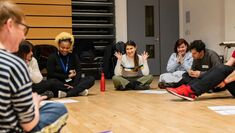 Students sitting in a circle discussing a play text