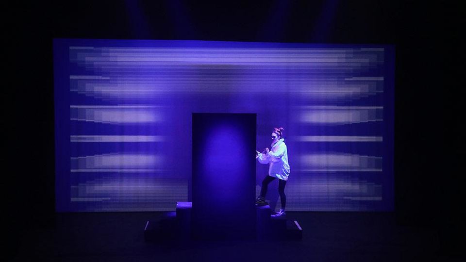 Student in front of a lighting installation