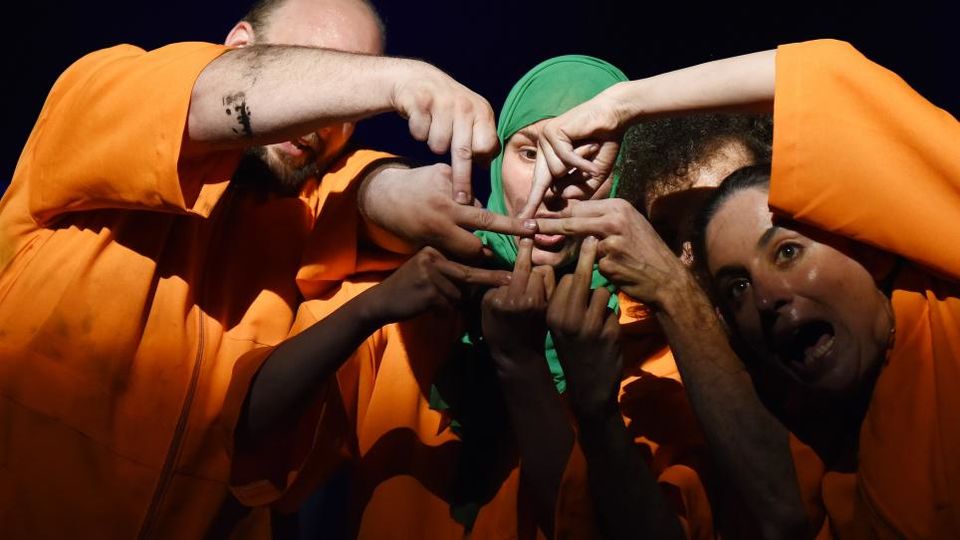 Hands of actors wearing orange robes