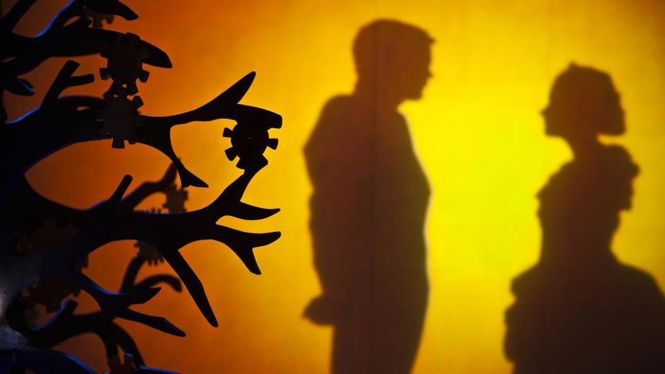 Silhouettes of actors performing with yellow light