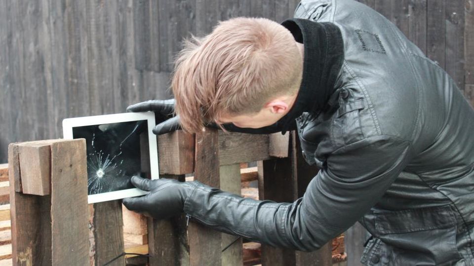 Artist holding iPad which has been shot
