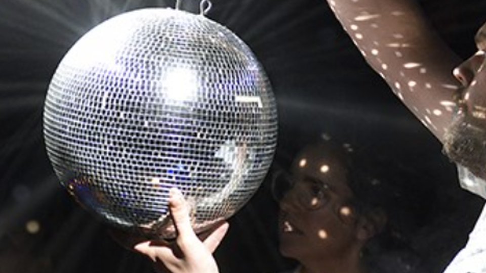 A disco ball being hung up