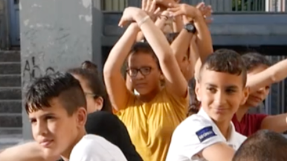 A group of children making shapes with their hands