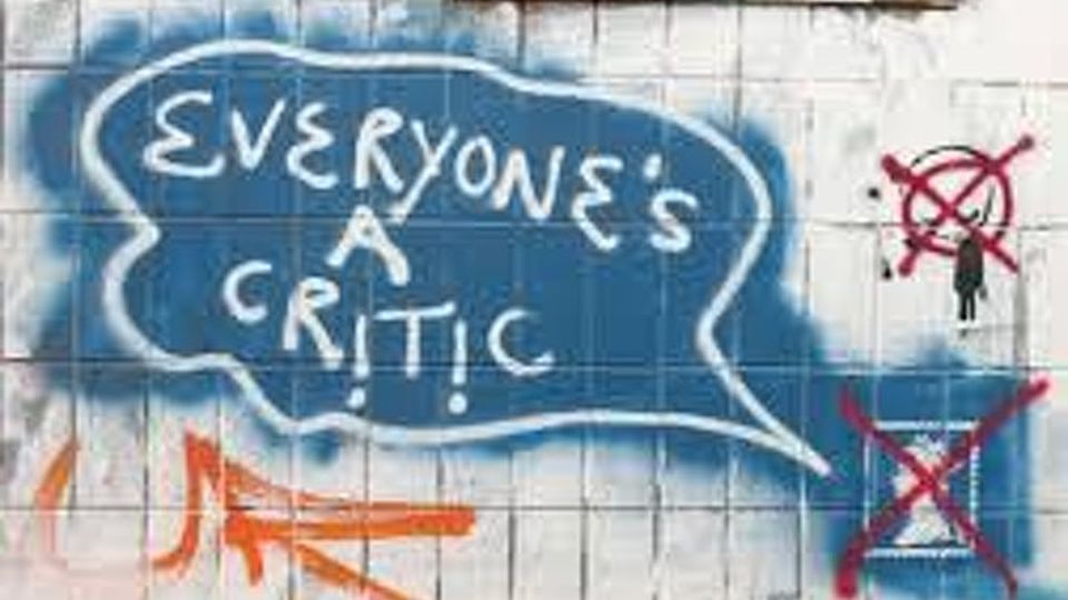 Wall with graffiti that says Everyone's a Critic