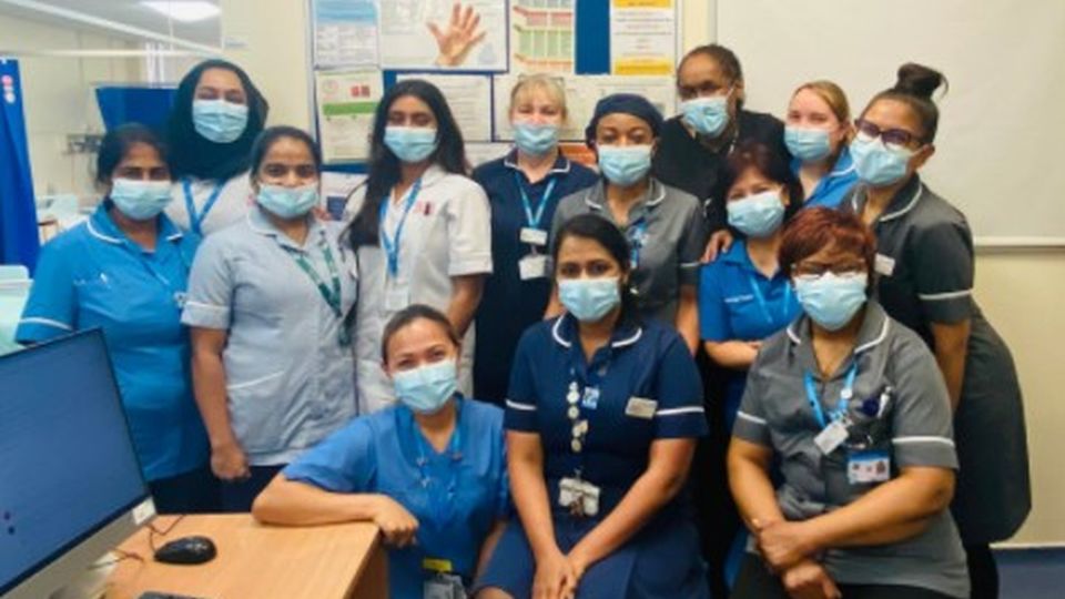 Staff from Lewis Loyd ward wearing face masks pose for photo