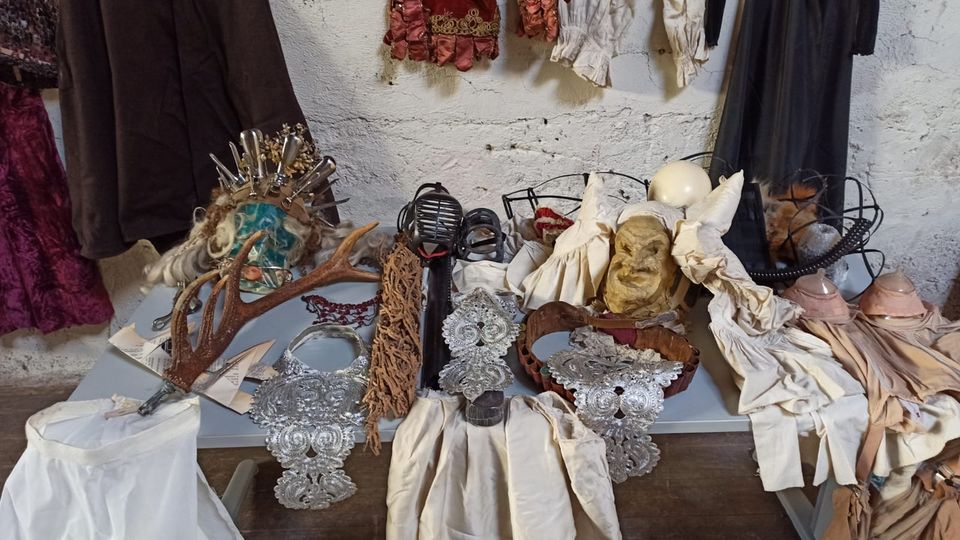 Costumes, headdresses, neckpieces and other accessories on a table