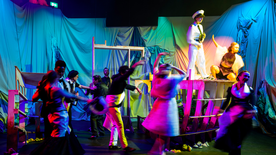 Production shot of students dancing on stage