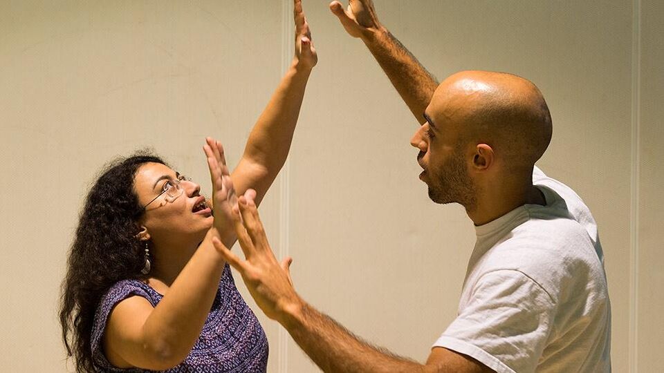 Two practitioners' hands meet in an exercise