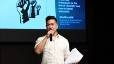 Broderick Chow holding a microphone and speaking
