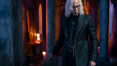 Photo showing Alex Hassell starring as Vicious in Netflix's Cowboy Bebop. Photo shows a white man (Alex) dressed in black with long grey hair and holding a sword. 