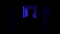 A silhouette in front of a dark blue background