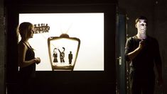 Two performers with shadow puppet booth