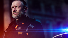 Image of actor Martin Freeman, dressed as a policeman and looking off to the distance