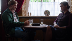 Image of actors Joe Alwyn and Honor Swinton Byrne in The Souvenir Part II, sitting together in a pub staring at each other across a table
