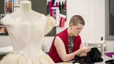 Student working on fabric next to mannequin