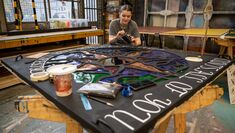A student works on a piece of set design in the studio