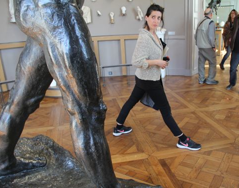 Person imitating movement in Rodin sculpture of Walking Man