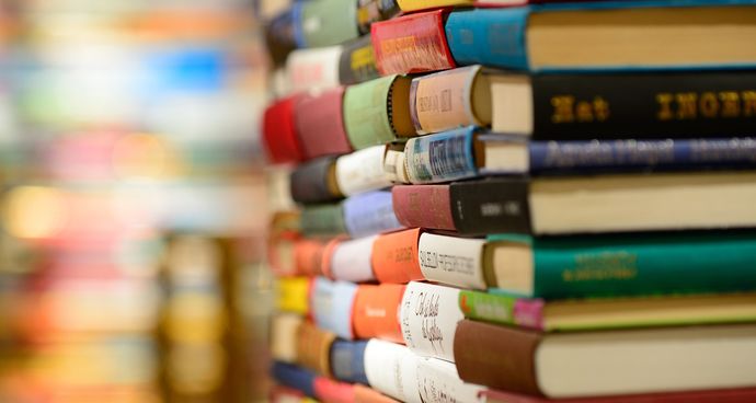 A close up image of colourful books in a stack
