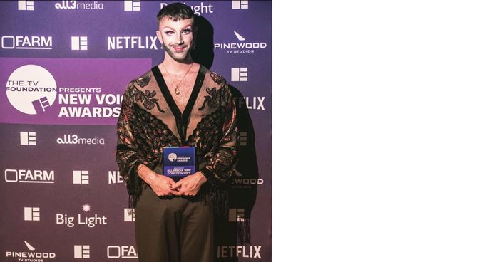 Callum Tilbury standing with his Edinburgh TV Festival New Voice Award