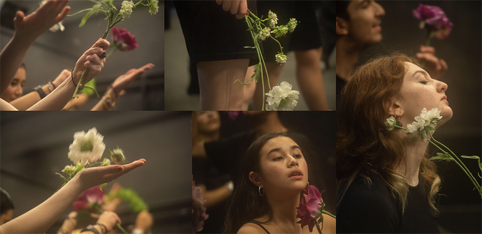 Actors posing with fresh flowers as a part of a performance