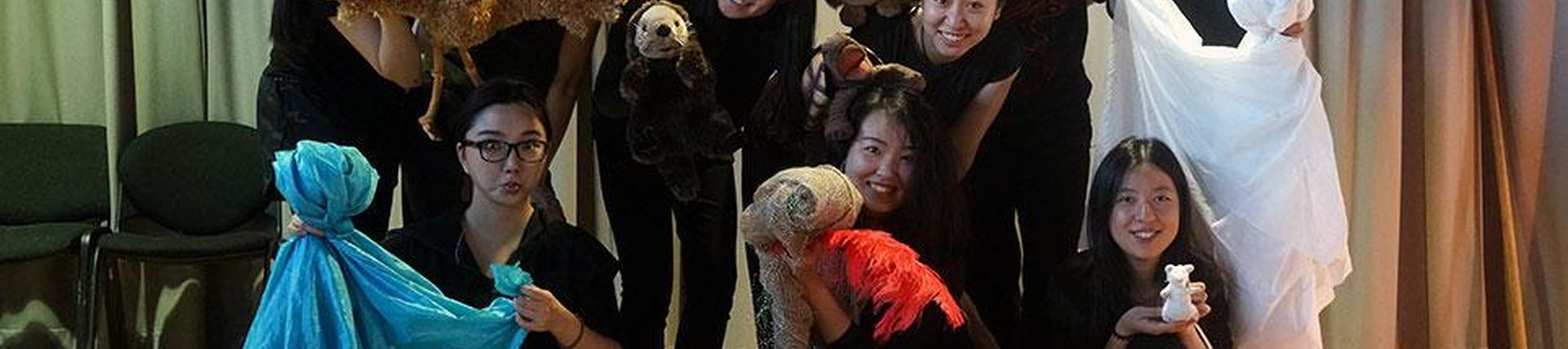 Artists posing with puppets
